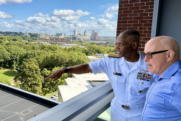 Two men looking out a window